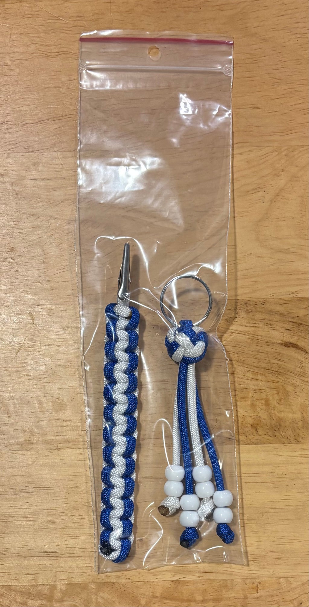 Blue and white keychain with matching card grabber/roach clip.